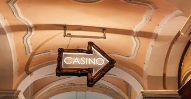 Casino Sign In The Form Of An Arrow Hanging From A Ceiling